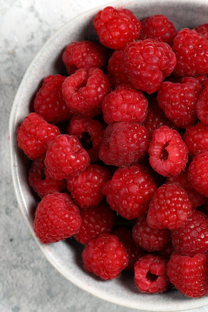 ripe organic berry red raspberry in a bowlの写真素材