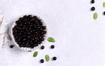 ripe organic blackcurrant berry in a bowl