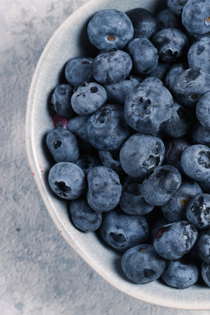 organic blueberries in bowl on gray backgroundの写真素材