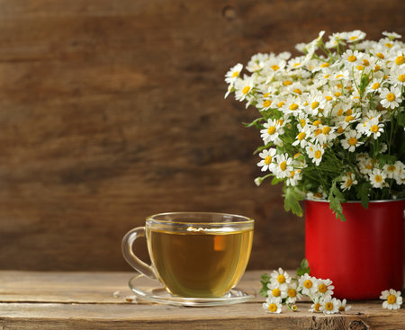 cup of herbal tea and a bouquet of chamomile flowersの写真素材