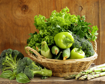 fresh organic green vegetables in basketの写真素材