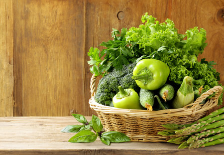 fresh organic green vegetables in basketの写真素材