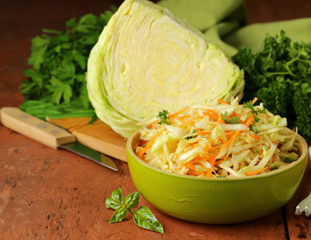 cabbage salad, coleslaw with herbs on the tableの写真素材