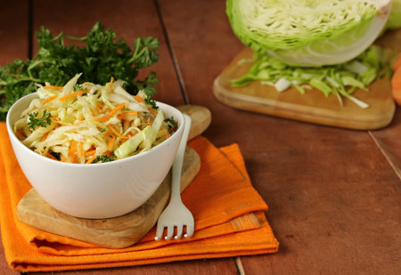 cabbage salad, coleslaw with herbs on the tableの写真素材
