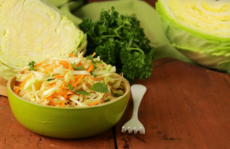 cabbage salad, coleslaw with herbs on the tableの写真素材