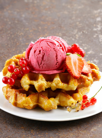 Belgian waffles with berries and ice creamの写真素材