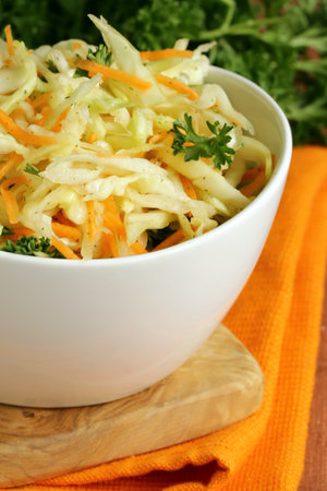 cabbage salad, coleslaw with herbs on the tableの写真素材