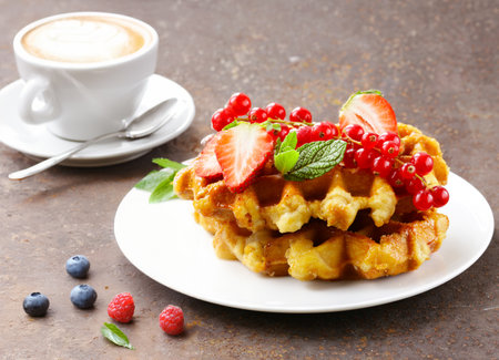 Belgian waffles with berries and ice creamの写真素材