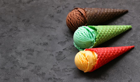 assorted ice cream of different flavors in waffle conesの写真素材