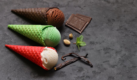 assorted ice cream of different flavors in waffle conesの写真素材