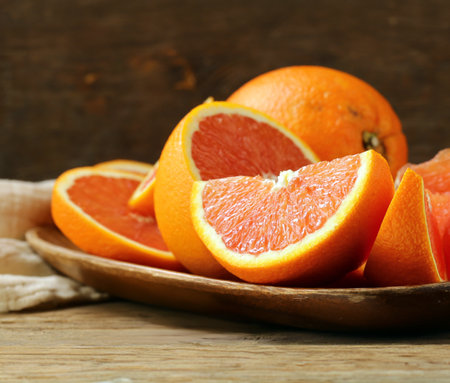 ripe organic juicy orange on wooden backgroundの写真素材