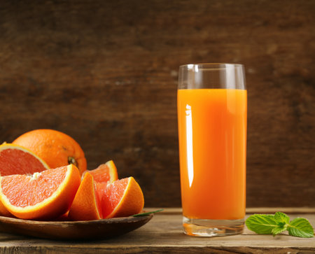 ripe organic juicy orange on wooden backgroundの写真素材