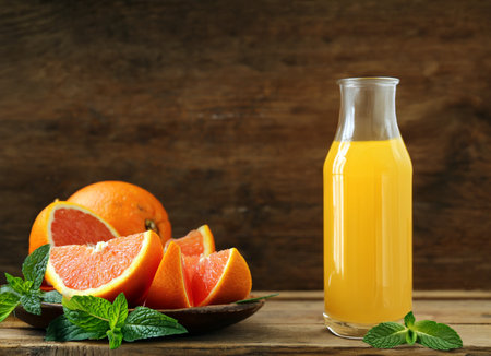 ripe organic juicy orange on wooden backgroundの写真素材