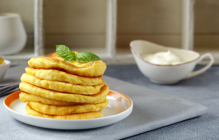 fried thin flatbreads with sauce on the tableの写真素材