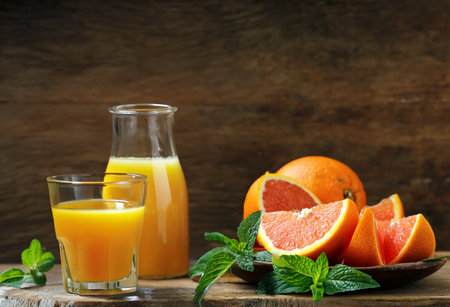 ripe organic juicy orange on wooden backgroundの写真素材
