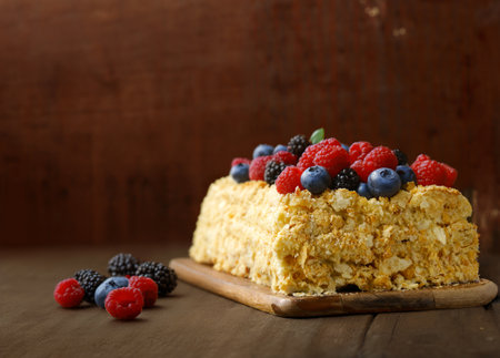 napoleon layered cake with berries on a wooden tableの写真素材