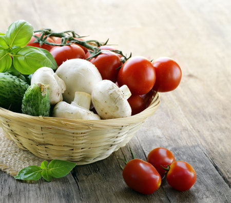 organic fresh vegetables in a basket on the tableの写真素材