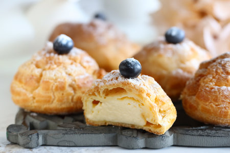 traditional choux pastry eclair dessert on a plateの写真素材