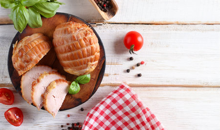 deli meats sausage on a wooden board for appetizerの写真素材