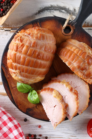 deli meats sausage on a wooden board for appetizerの写真素材