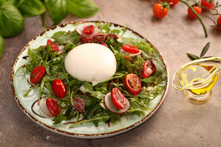 salad with burrata cheese on a plateの写真素材
