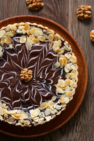 cake with nuts and chocolate on a wooden tableの写真素材