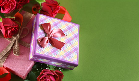gift boxes and flowers on green backgroundの写真素材