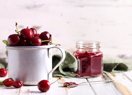 organic cherry jam and fresh berriesの写真素材