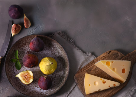 cheese on a board and fresh fruit for a snackの写真素材
