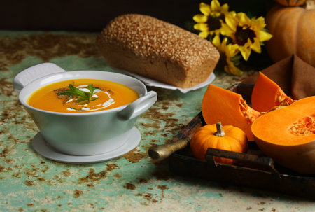 traditional pumpkin soup in a bowl on the tableの写真素材