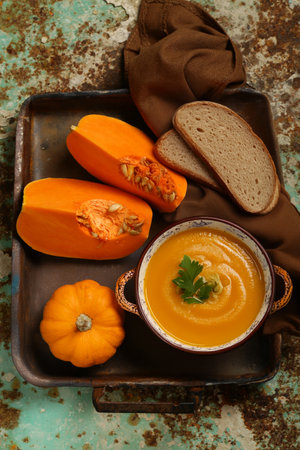 traditional pumpkin soup in a bowl on the tableの写真素材