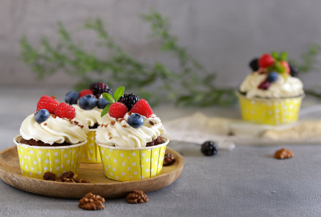 cupcakes with cream and holiday candlesの写真素材