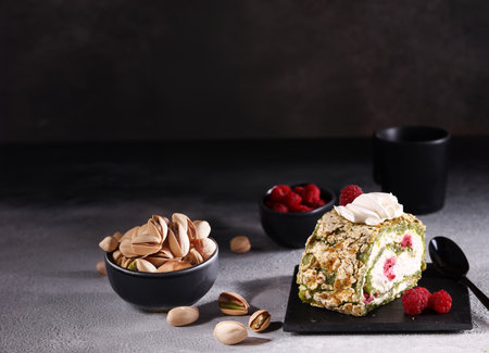meringue roll with pistachios and fresh raspberriesの写真素材