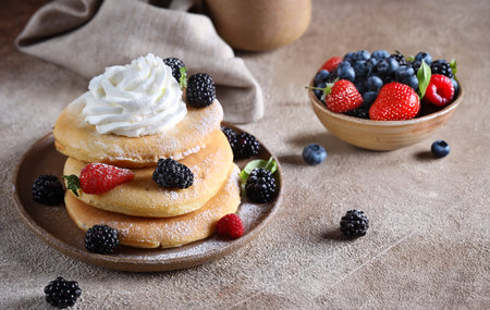 american pancakes with fresh berries for breakfastの写真素材