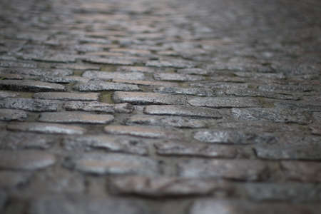 Dark cobblestones shot from the ground with very direct and dramatic light, shot in brussels in...