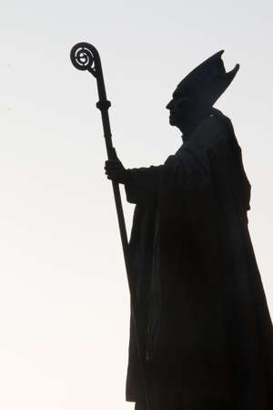 Silhouette of a pope statue on sunny evening in brussels in black and white