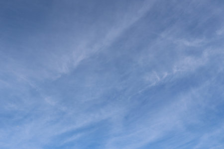 blue sky in late summer with light cirrus or cirrocumulus clouds as background