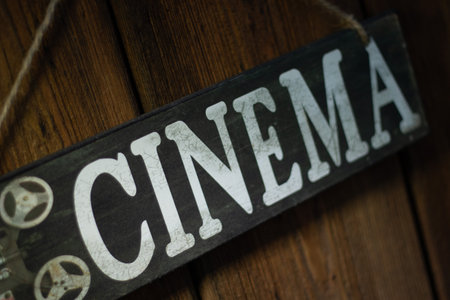 Cinema Sign Displayed on a Rustic Wooden Background, Evoking Vintage Charm and Nostalgiaの写真素材