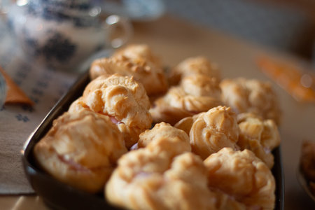 Freshly Baked Cream Puffs Arranged on Trays, Highlighting Their Golden and Fluffy Texture
