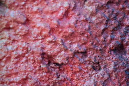 Close up of rough red textured wall surface with peeling paint - abstract background from Leipzig