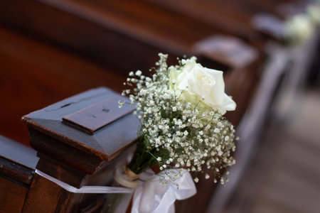 White rose and babys breath decoration on church pew-wedding or ceremonyの写真素材