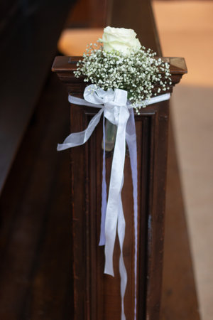 White rose and babys breath decoration on church pew-wedding or ceremonyの写真素材