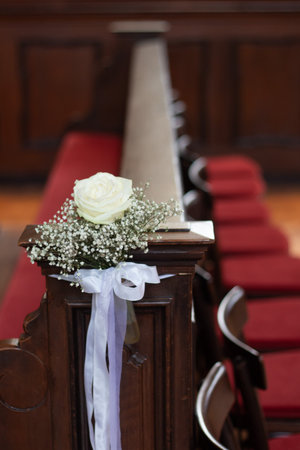 White rose and babys breath decoration on church pew-wedding or ceremonyの写真素材