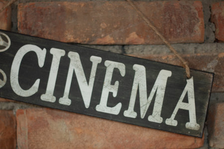 Old wooden Cinema sign on a brick wall-entertainment and vintageの写真素材