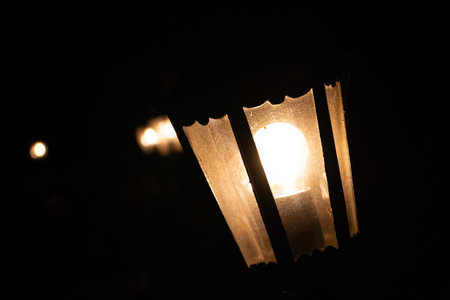 Street light glowing at night with strong rays-urban illuminationの写真素材