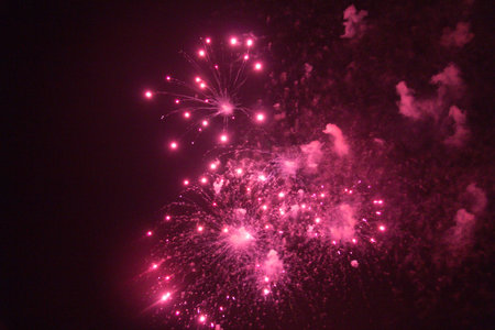 Colorful fireworks exploding in a dark night sky-celebration and lightの写真素材
