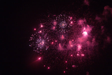 Colorful fireworks exploding in a dark night sky-celebration and lightの写真素材
