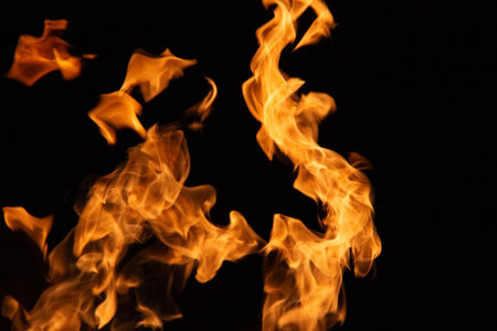 Isolated flames rising against black background with dynamic fiery shapes