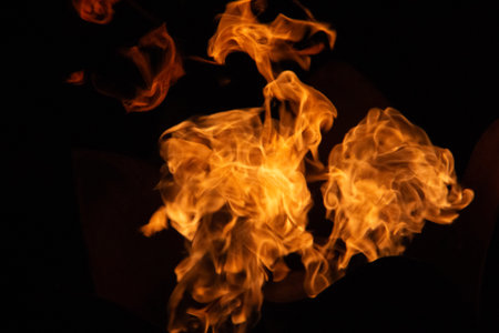 Isolated flames rising against black background with dynamic fiery shapes