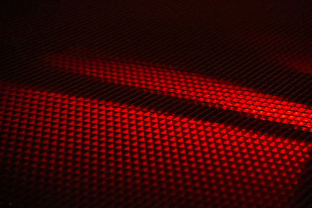 Red and black textured surface with diagonal light shadows in abstract patternの写真素材